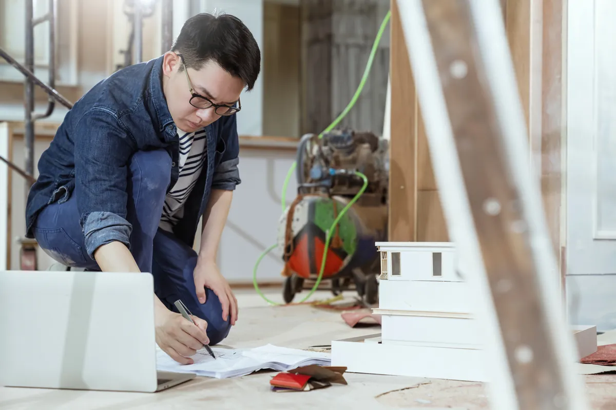 Contractor checking renovation plans for a home improvement client