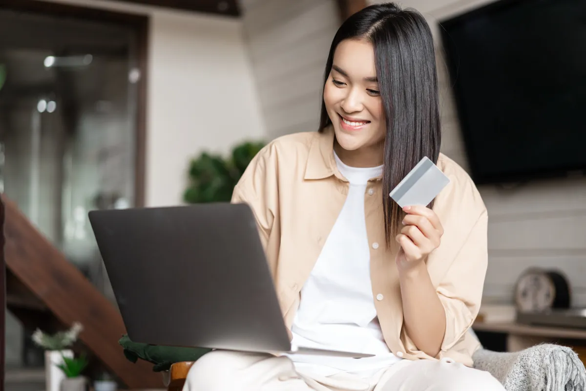 Customer paying for an online order by credit card on a laptop