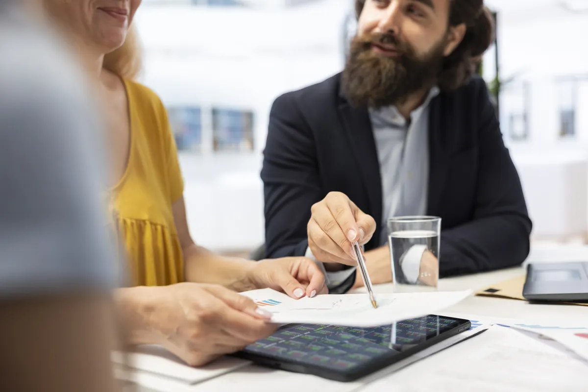 Financial advisor reviewing a client plan for a finance-industry campaign