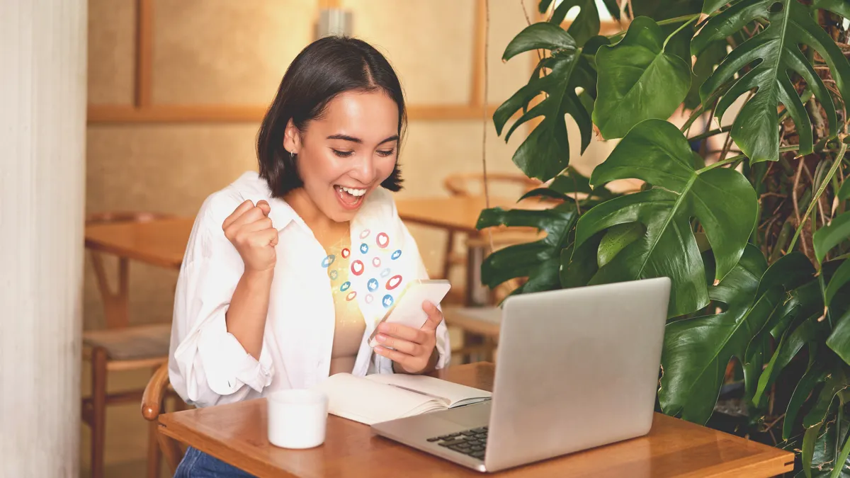 Singapore business owner celebrating new customer reviews and enquiries on her phone